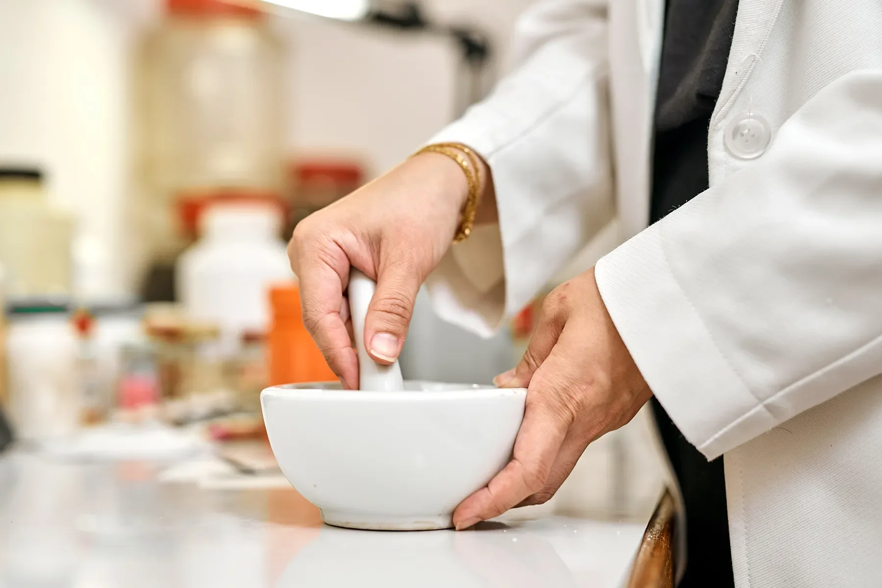 Pharmacist compounding custom medication in NYC laboratory