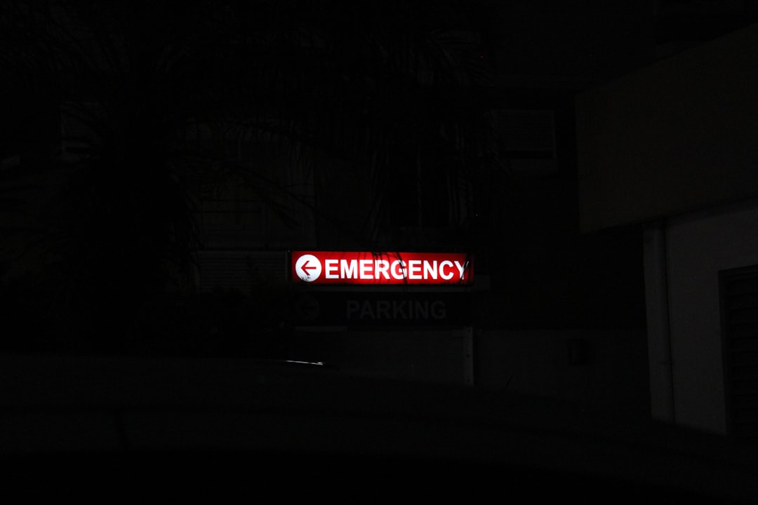 24 hour pharmacy emergency sign glowing at night for urgent medication access