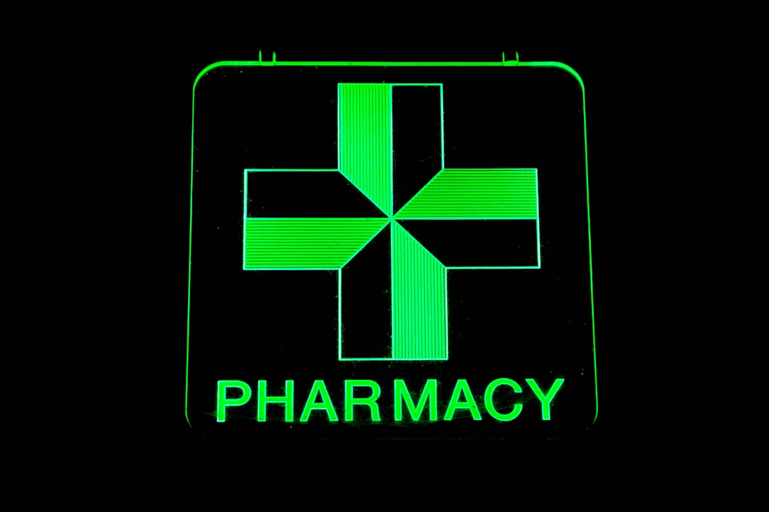 24 hour pharmacy green cross sign illuminated for NYC emergency services