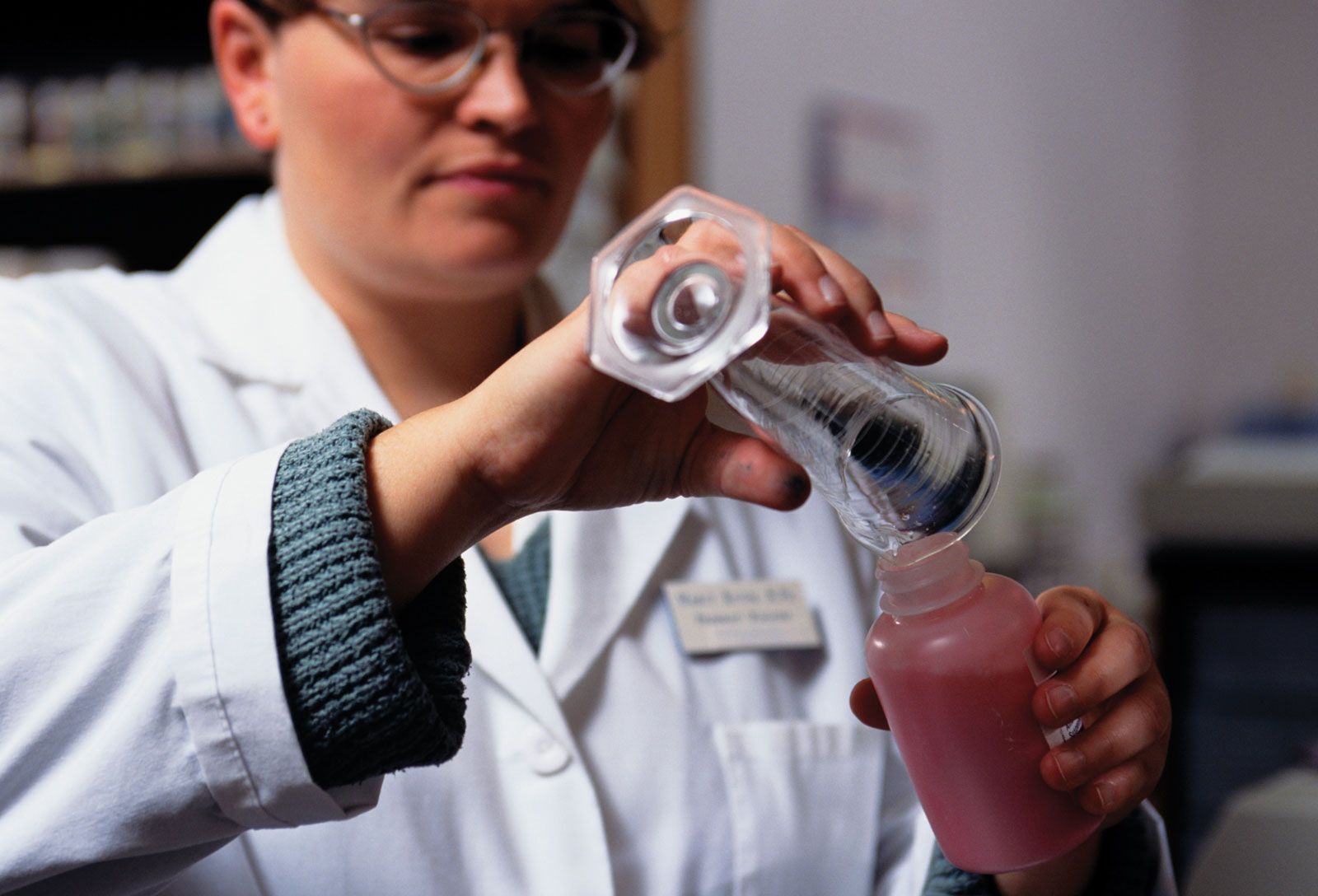 Pharmacist preparing custom compounded medication using professional equipment