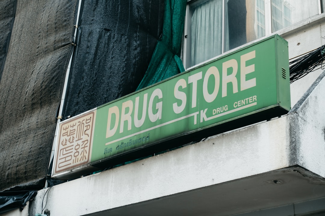 Queens pharmacy green sign building providing community pharmaceutical care
